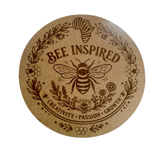 Round mdf coaster with bee design and 'Bee Inspired' text and an Africa map on a white background