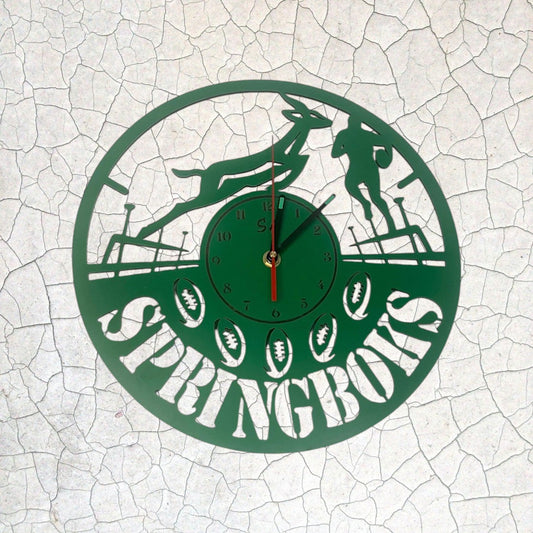 Green clock with 'Springboks' design on a white cracked surface