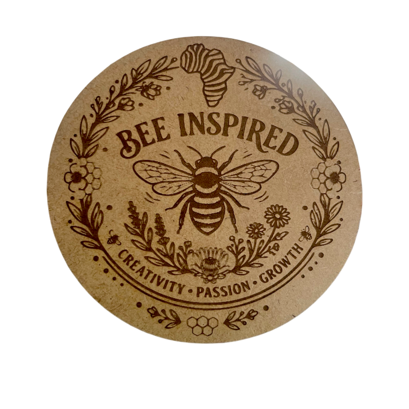 Round mdf coaster with bee design and 'Bee Inspired' text and an Africa map on a white background