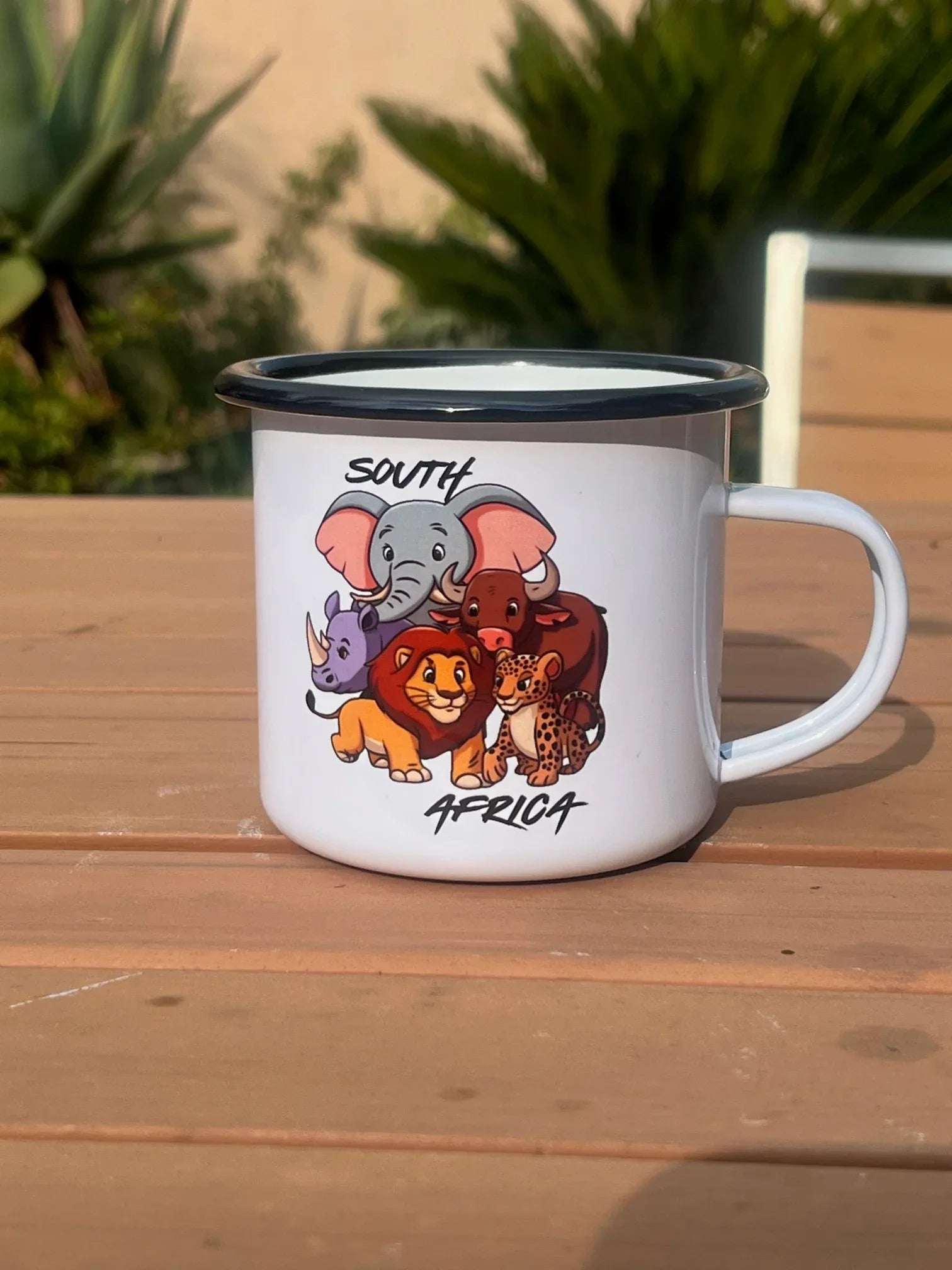 Vintage enamel mug with cartoon South African wildlife illustration, ideal for nostalgic and heritage-themed gifts.