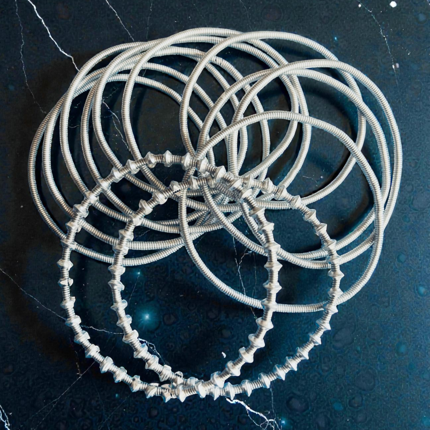 Mixed Venda Bangles/bracelets on a dark textured background