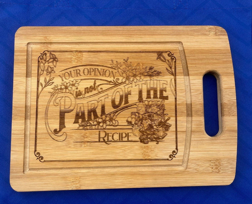 Wooden cutting board with engraved design on a blue surface