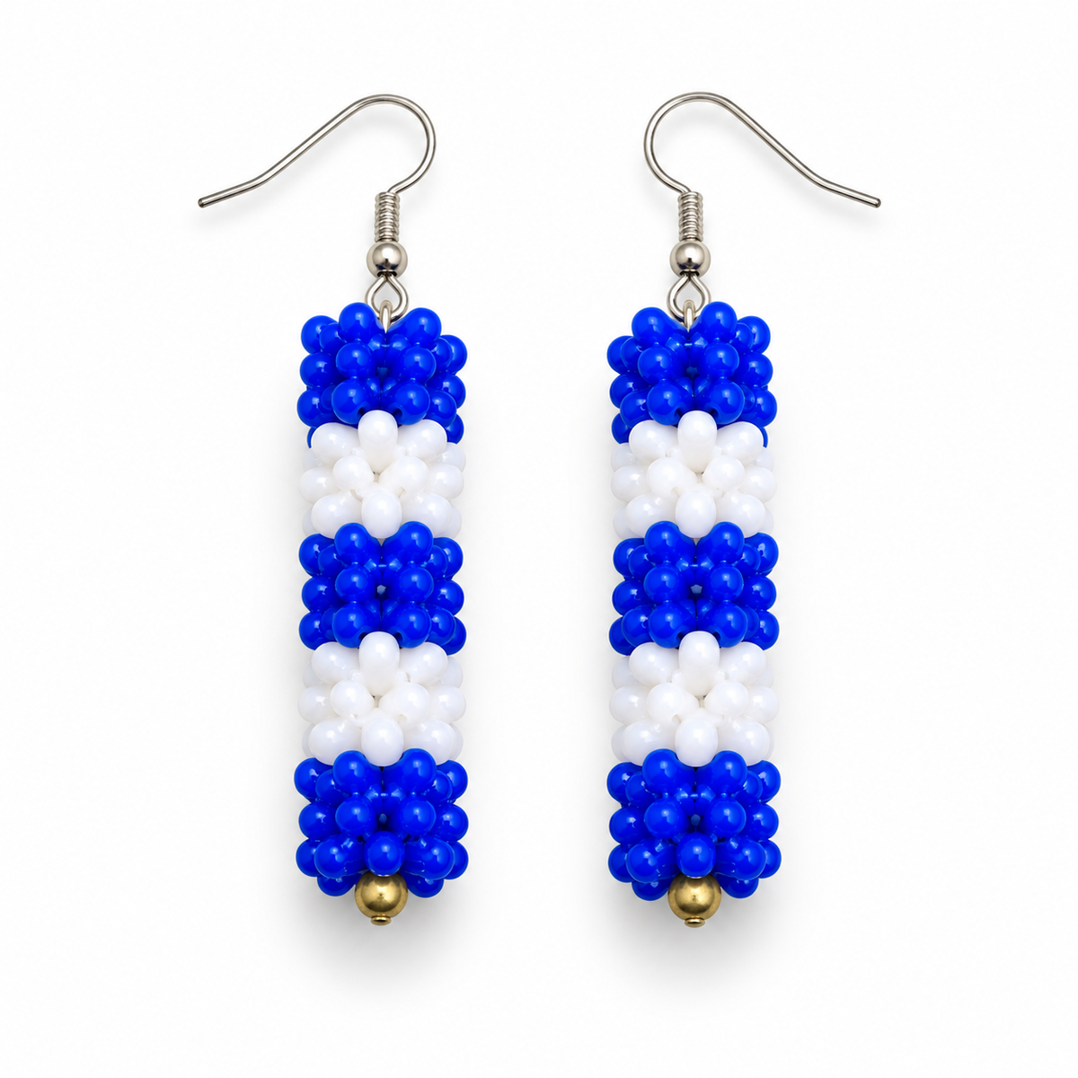 Long Blue & White plastic snowflake bead earrings on white background
