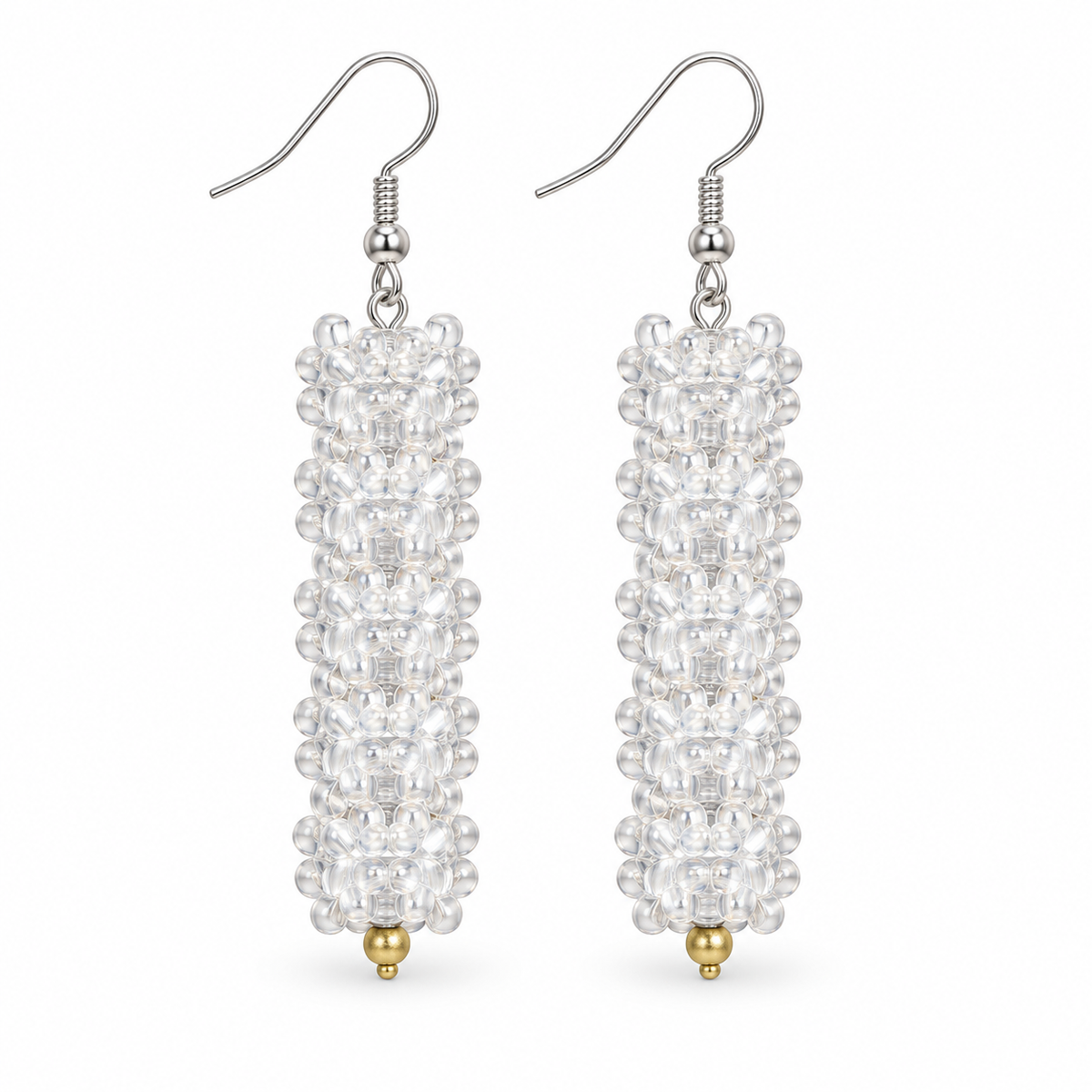 Long Clear plastic snowflake bead earrings on white background