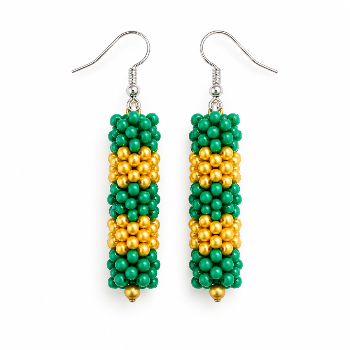 Long Green & Gold plastic snowflake bead earrings on white background