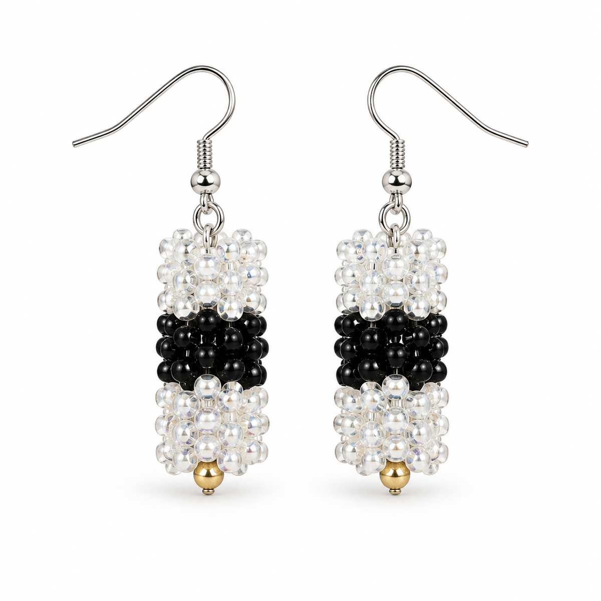 Short Black & Clear plastic snowflake bead earrings on white background