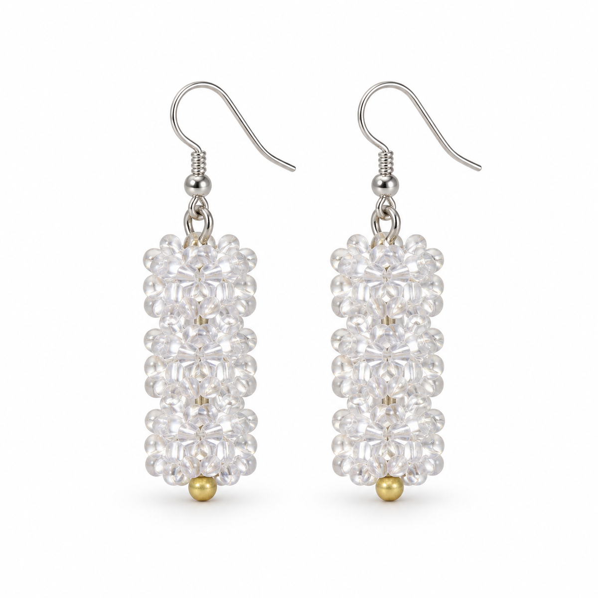 Short Clear plastic snowflake bead earrings on white background