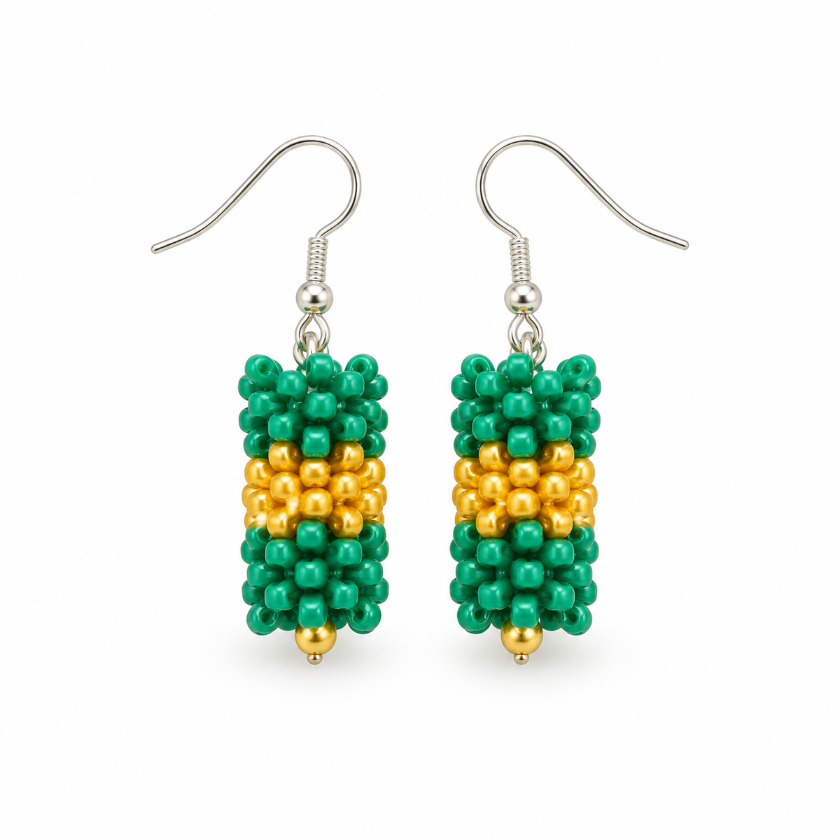 Short Green & Gold plastic snowflake bead earrings on white background